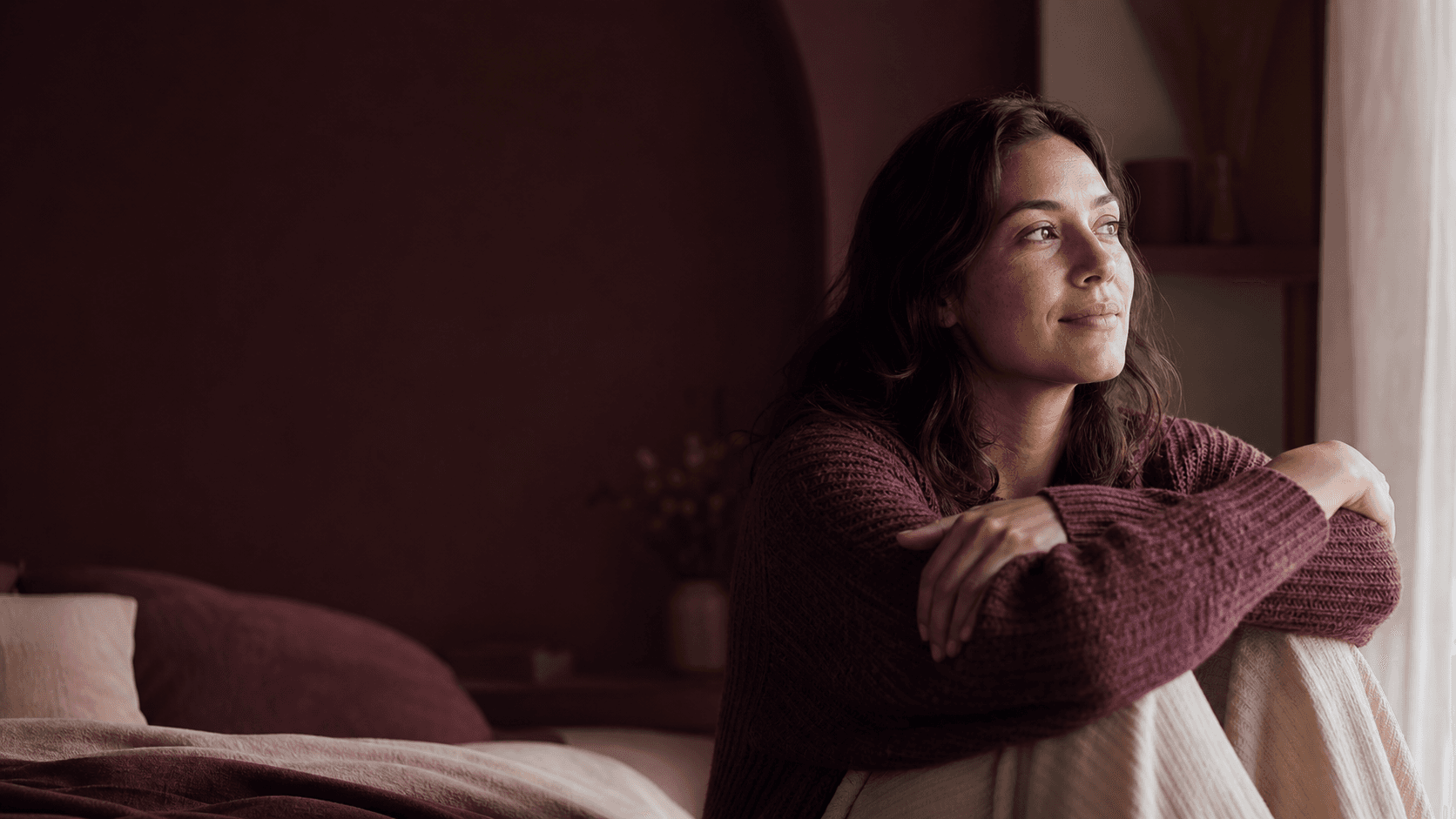 A woman enjoying a quiet moment by the window